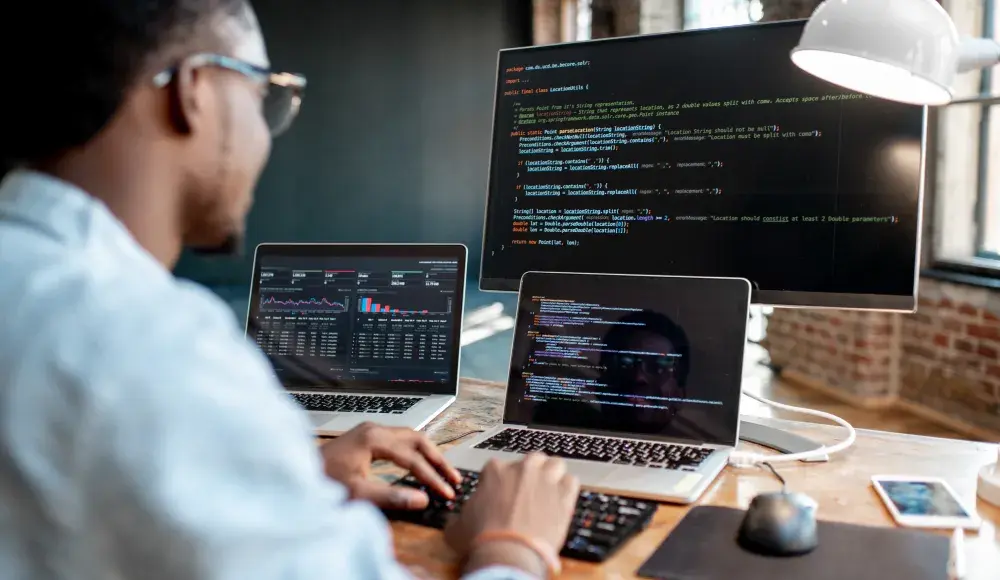 Man in front of laptops and a screen with VeriFactu API software